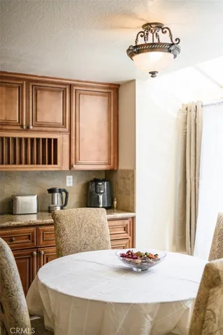 a bedroom with a bed and a potted plant on the dresser