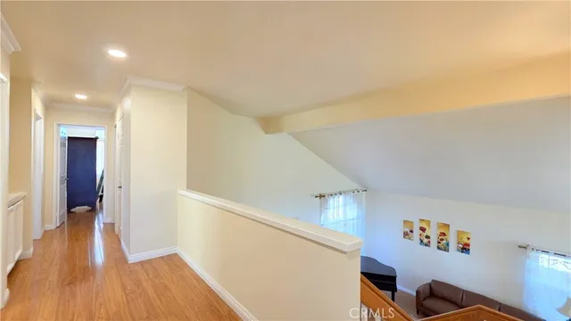 a view of hallway with wooden floor