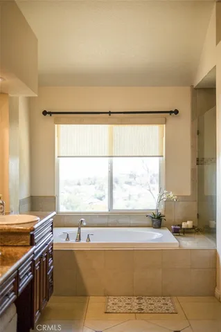 a living room with a large window and a fireplace