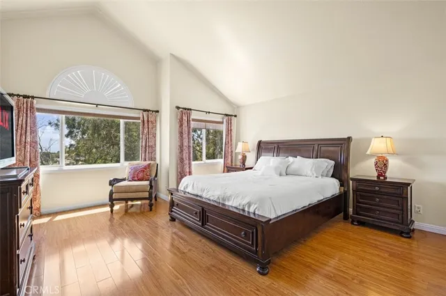 a bedroom with a bed and a large window