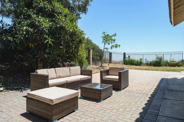 a view of a patio with couches and potted plants