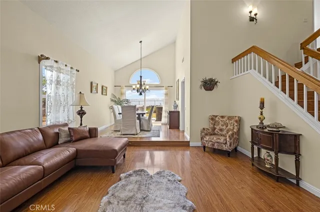 a living room with furniture fireplace and wooden floor