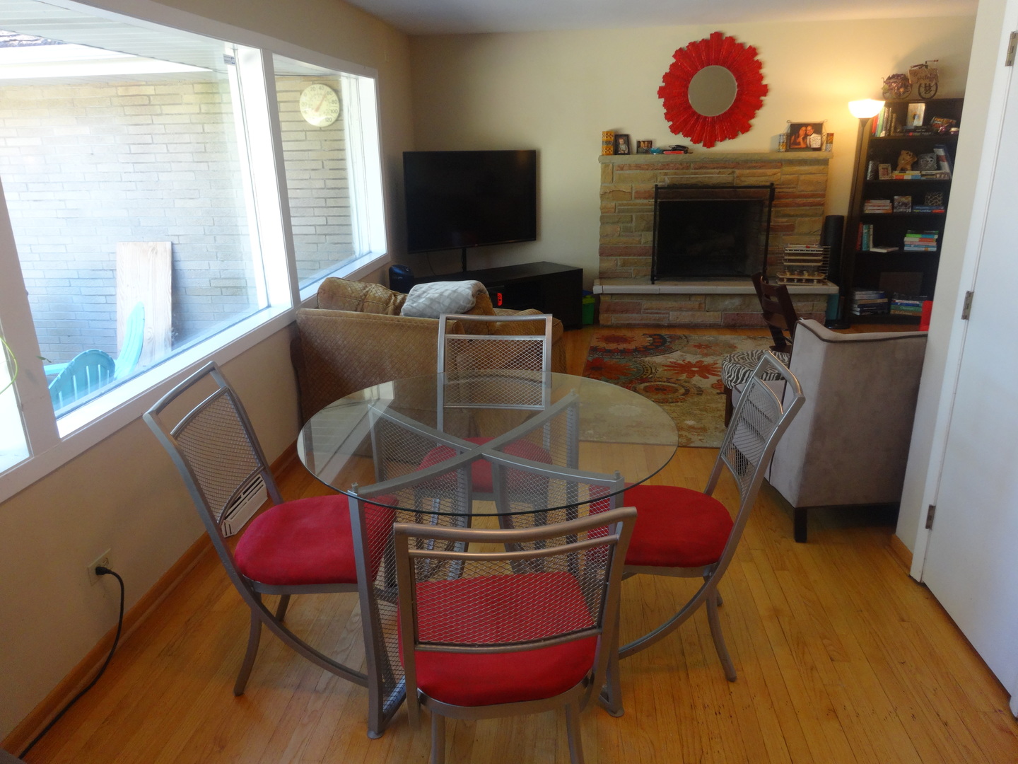 22W678 Poplar Road Glen Ellyn, IL 60137 - Photo 14 of 37 a living room with furniture a flat screen tv and a fireplace