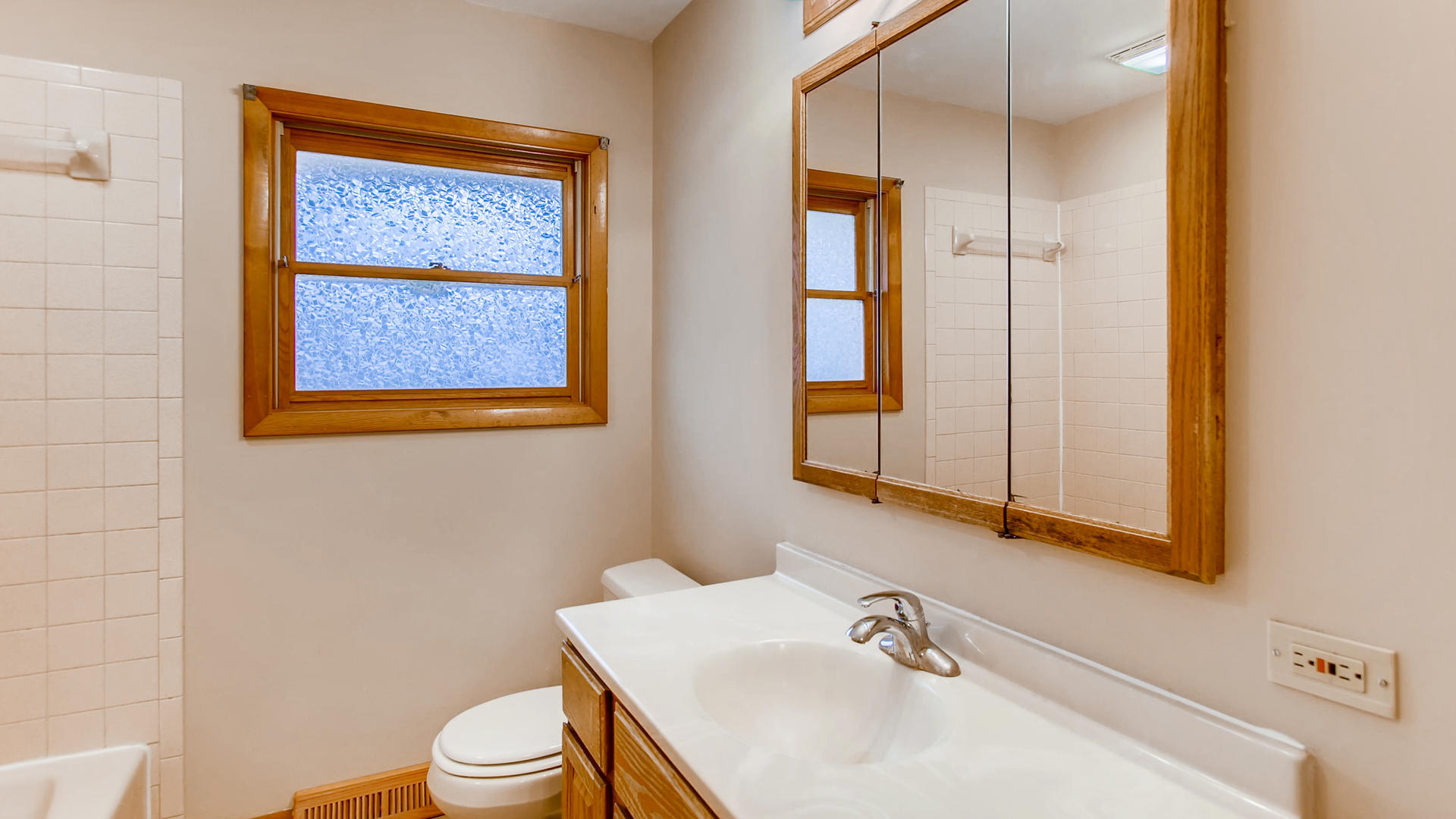 22W678 Poplar Road Glen Ellyn, IL 60137 - Photo 26 of 37 a bathroom with a sink a toilet and mirror