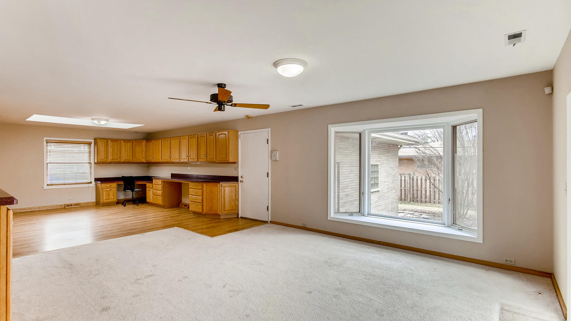 22W678 Poplar Road Glen Ellyn, IL 60137 - Photo 5 of 37 an empty room with furniture and a large window