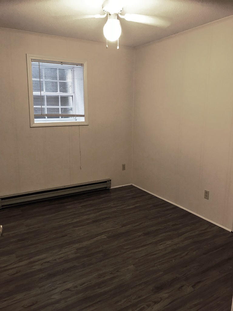 406 Old Central Road, Unit 1 Clemson, SC 29631 - Photo 3 of 8 This inviting room features resilient vinyl flooring, a bright window, and a cooling ceiling fan.