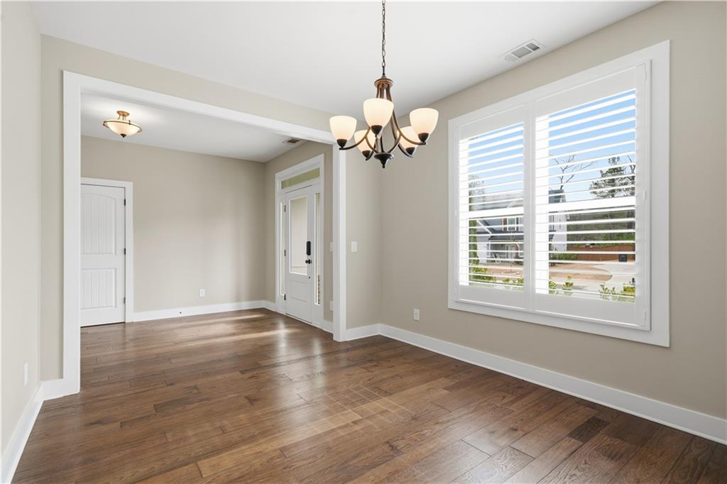 12 Bridgestone Way Cartersville, GA 30120 - Photo 16 of 46 a view of an empty room with a window and wooden floor