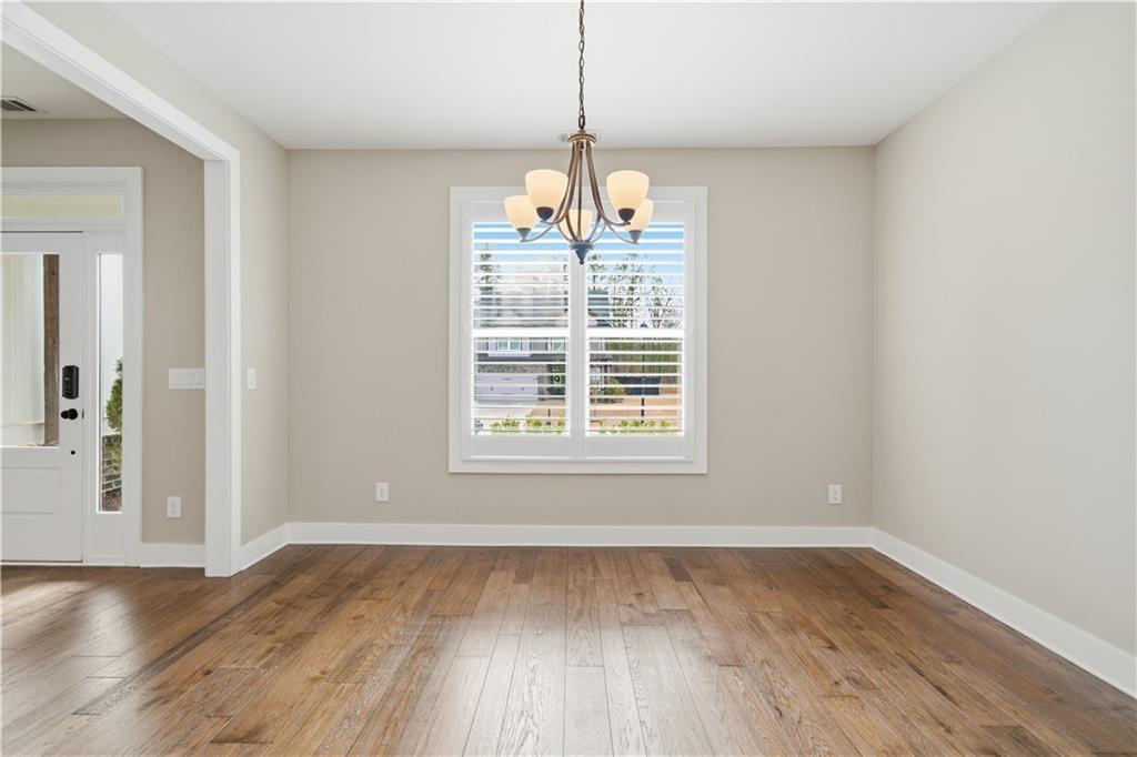 12 Bridgestone Way Cartersville, GA 30120 - Photo 17 of 46 an empty room with wooden floor and windows