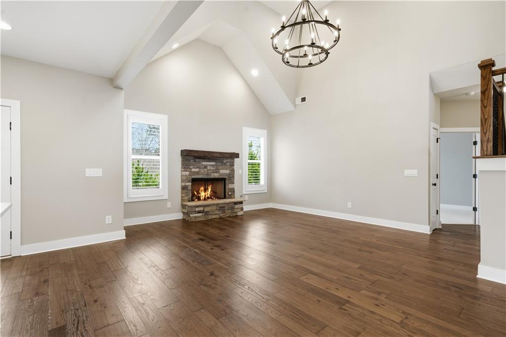 12 Bridgestone Way Cartersville, GA 30120 - Photo 20 of 46 an empty room with wooden floor fire place and windows
