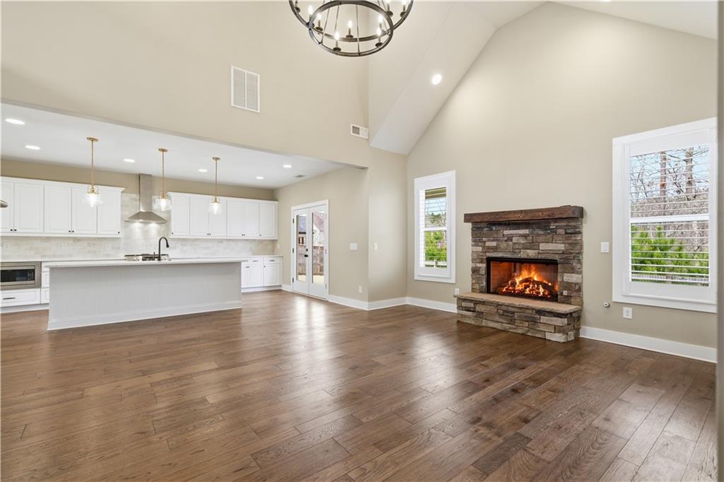 12 Bridgestone Way Cartersville, GA 30120 - Photo 21 of 46 an empty room with wooden floor a fireplace and windows
