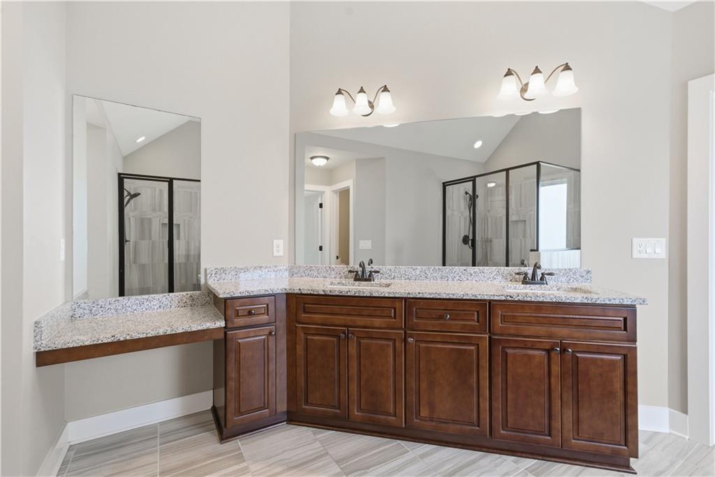 12 Bridgestone Way Cartersville, GA 30120 - Photo 7 of 46 a bathroom with a granite countertop sink and a mirror