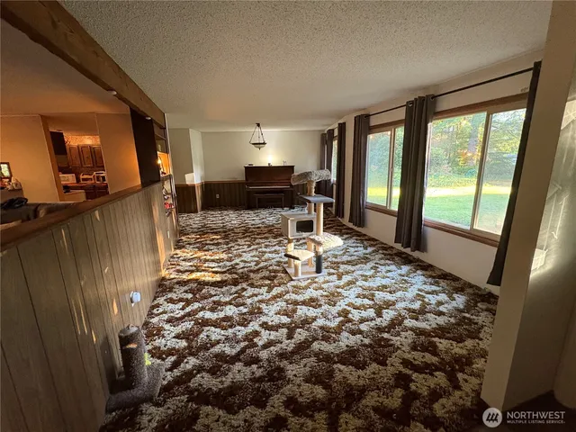 a living room with furniture a large window with wooden floor