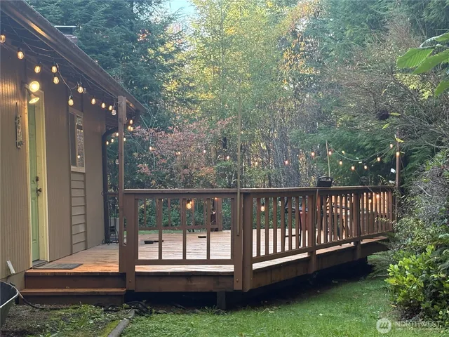 a view of a deck with a floor to ceiling window and wooden fence
