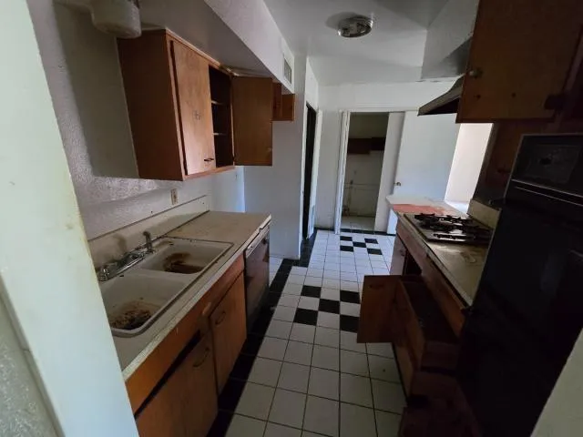 a kitchen with a sink appliances and cabinets