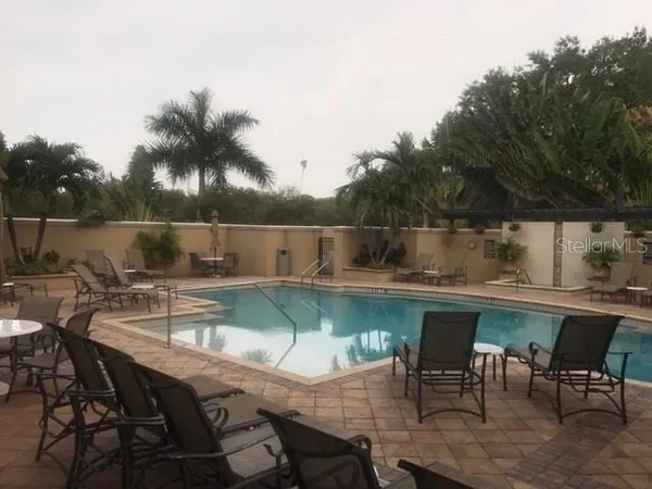 a view of a chairs and table in patio