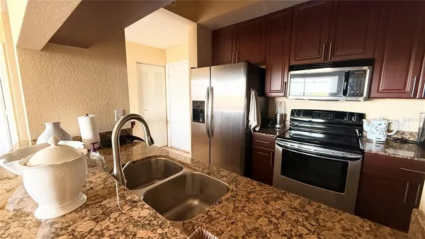a kitchen with a stove and a refrigerator