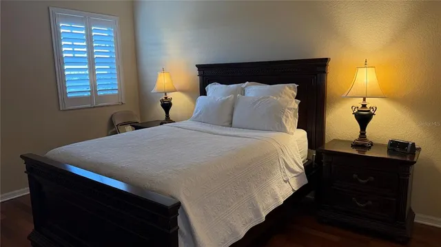 a bathroom with a granite countertop sink mirror vanity and toilet
