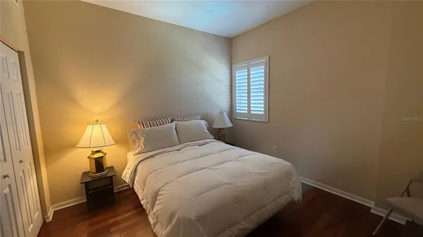 a bedroom with a bed and a window