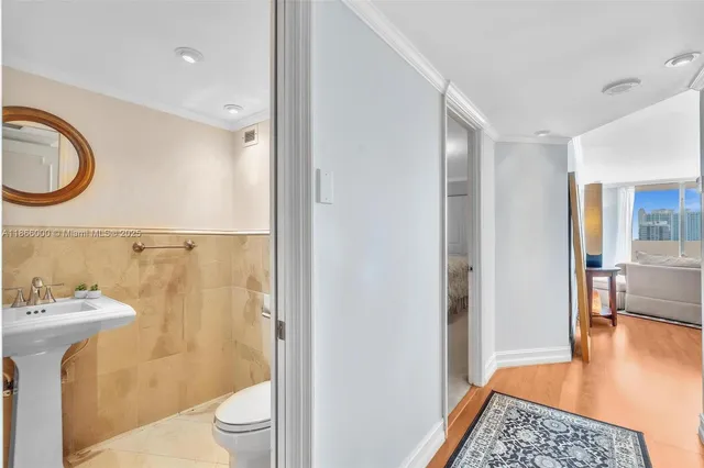 a living room with fireplace furniture and a potted plant