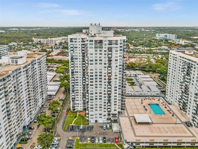 a balcony with a bench and trees