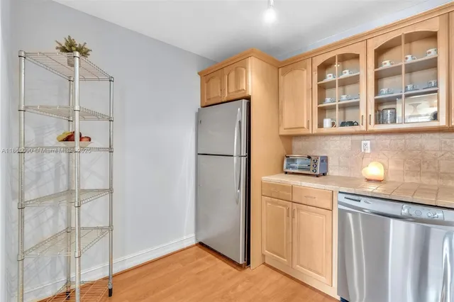 a kitchen with cabinets appliances and a sink