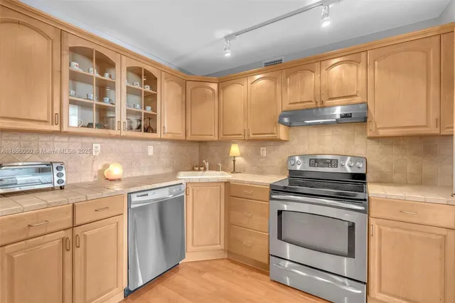 a kitchen with granite countertop a stove and a microwave
