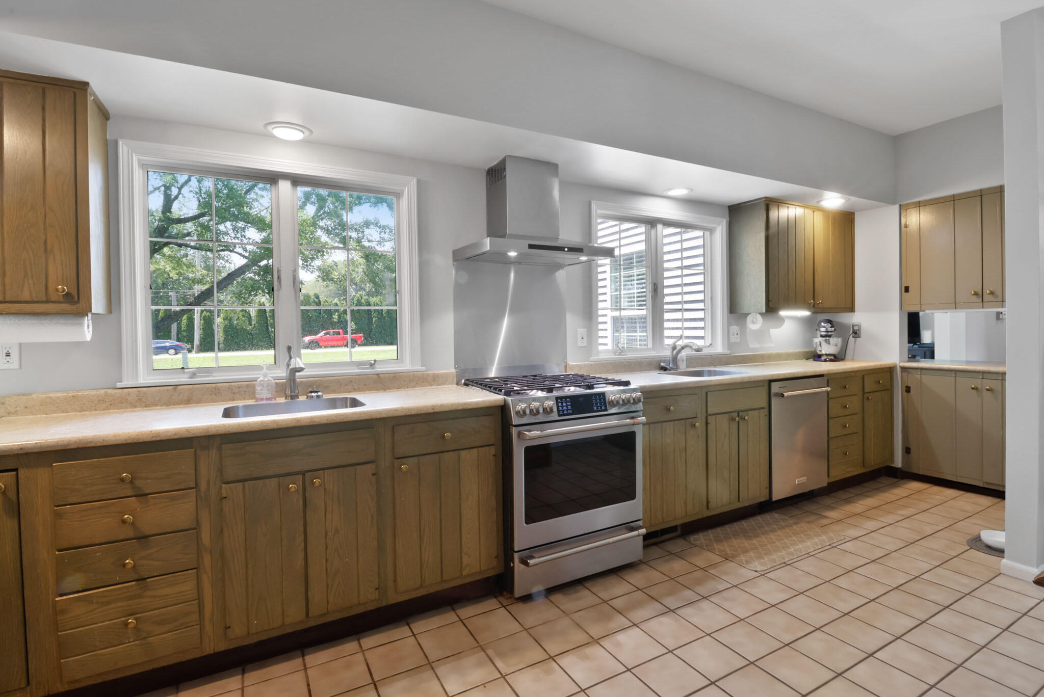12819 Grant Street Crown Point, IN 46307 - Photo 13 of 42 a kitchen with stainless steel appliances a sink window and cabinets
