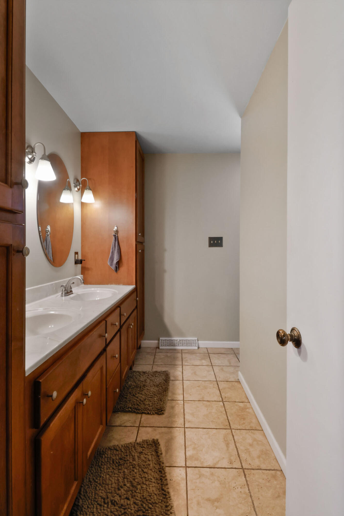 12819 Grant Street Crown Point, IN 46307 - Photo 16 of 42 a bathroom with a double vanity sink and a mirror