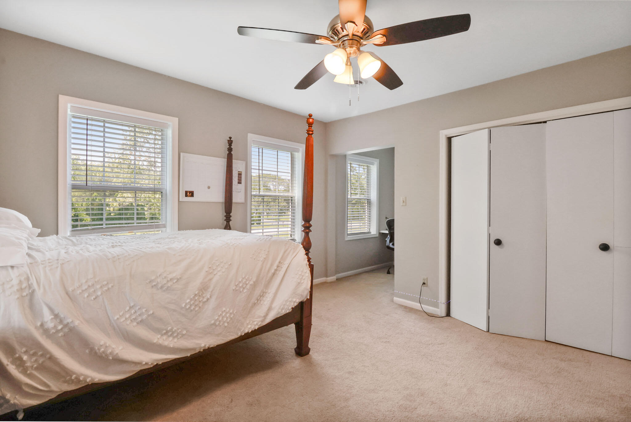 12819 Grant Street Crown Point, IN 46307 - Photo 24 of 42 a spacious bedroom with a bed and a chandelier