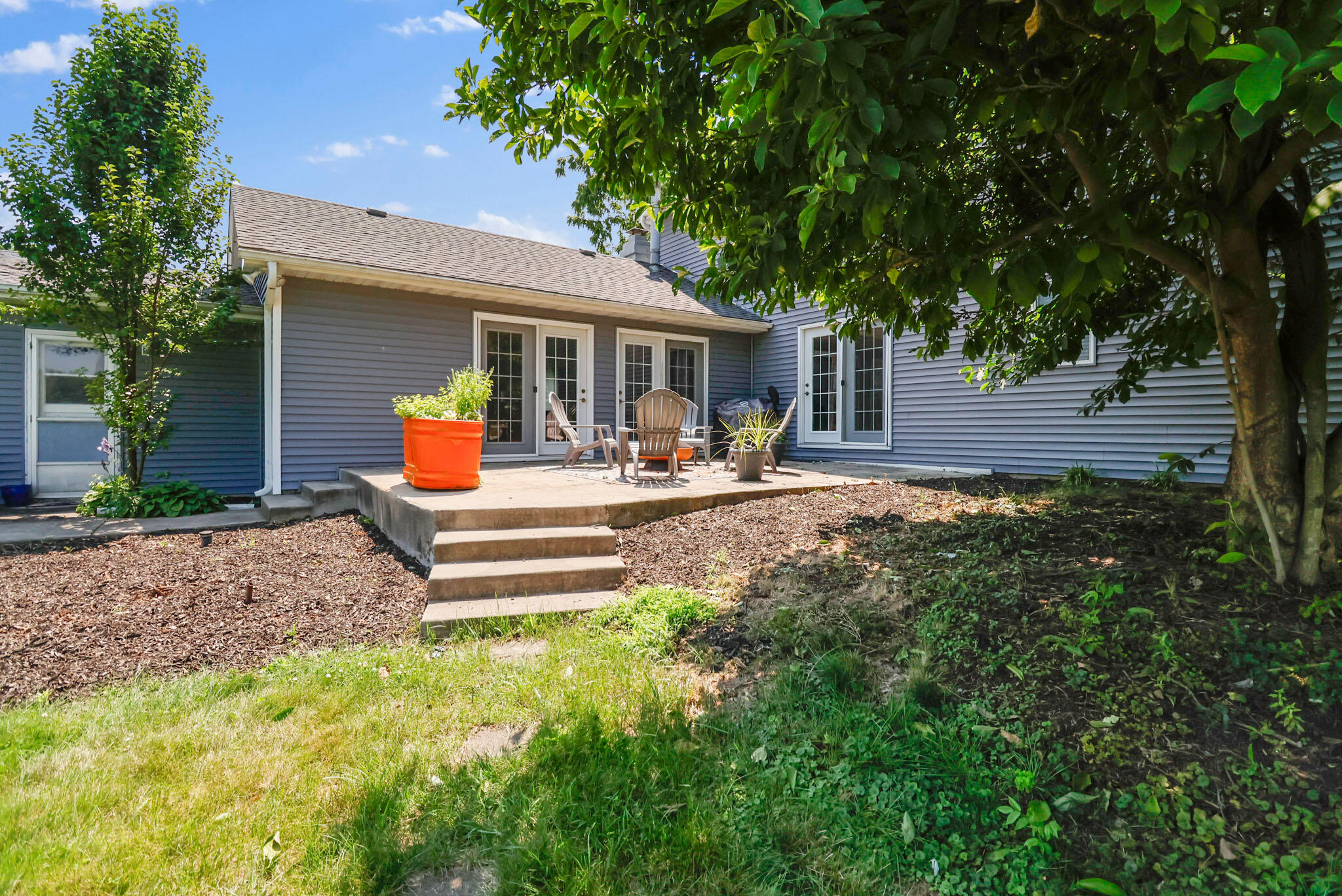 12819 Grant Street Crown Point, IN 46307 - Photo 29 of 42 a wooden bench sitting in front of a house