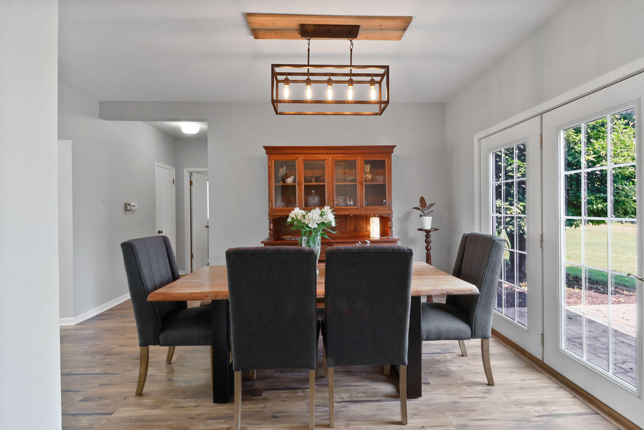 12819 Grant Street Crown Point, IN 46307 - Photo 6 of 42 a view of a dining room with furniture a chandelier and wooden floor