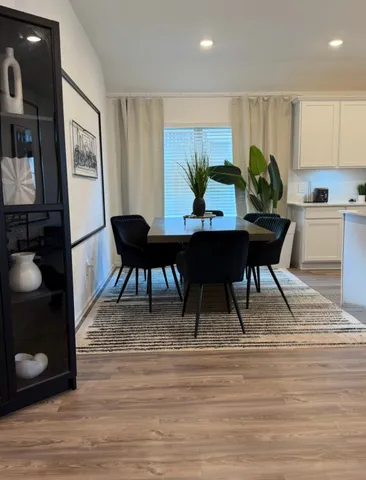 a view of a dining room with furniture and wooden floor