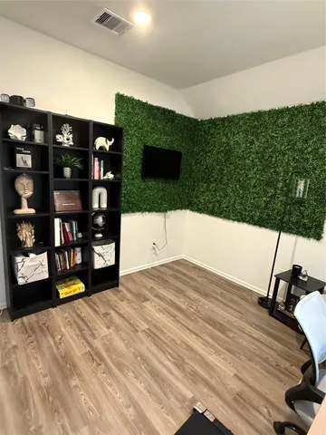 a living room with furniture and a wooden floor