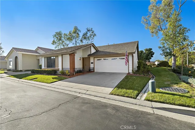 a view of a house with a yard and a garage