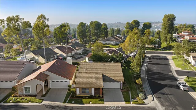 an aerial view of multiple houses with yard