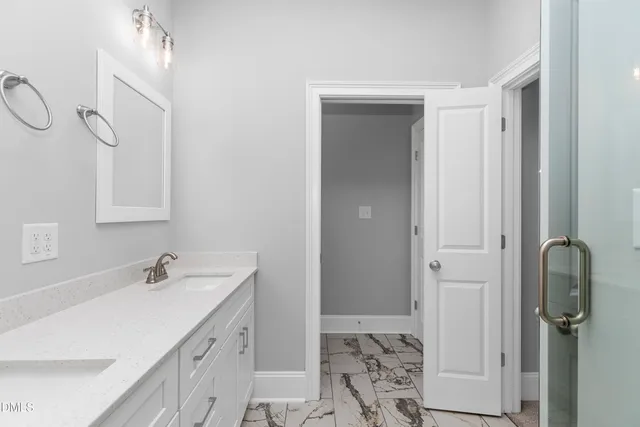 a bathroom with a sink vanity and a mirror