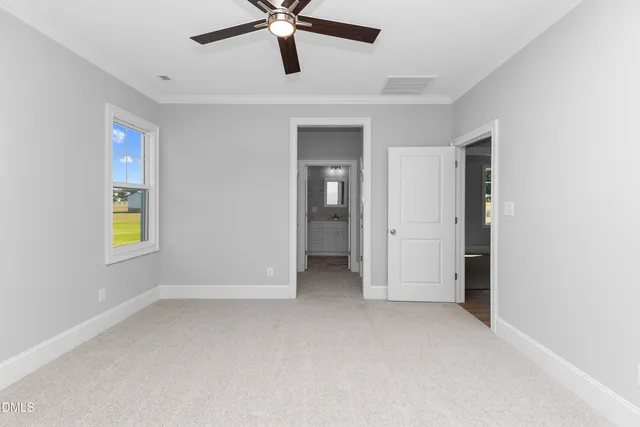 an empty room with window and closet area