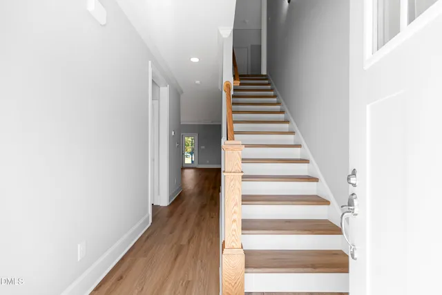 a view of entryway and gallery with wooden floor