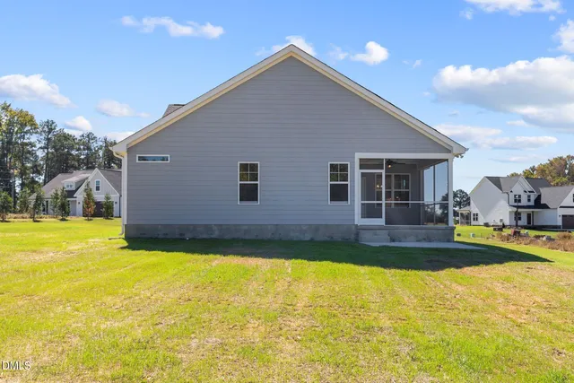 a view of a house with swimming pool and a yard