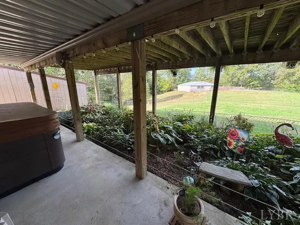 a view of a porch with furniture and garden