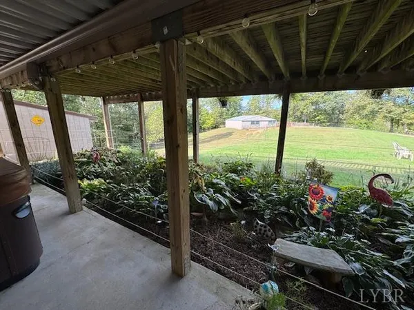 a view of a porch with furniture and garden