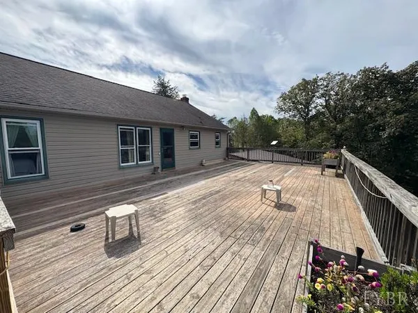 a view of a house with wooden deck