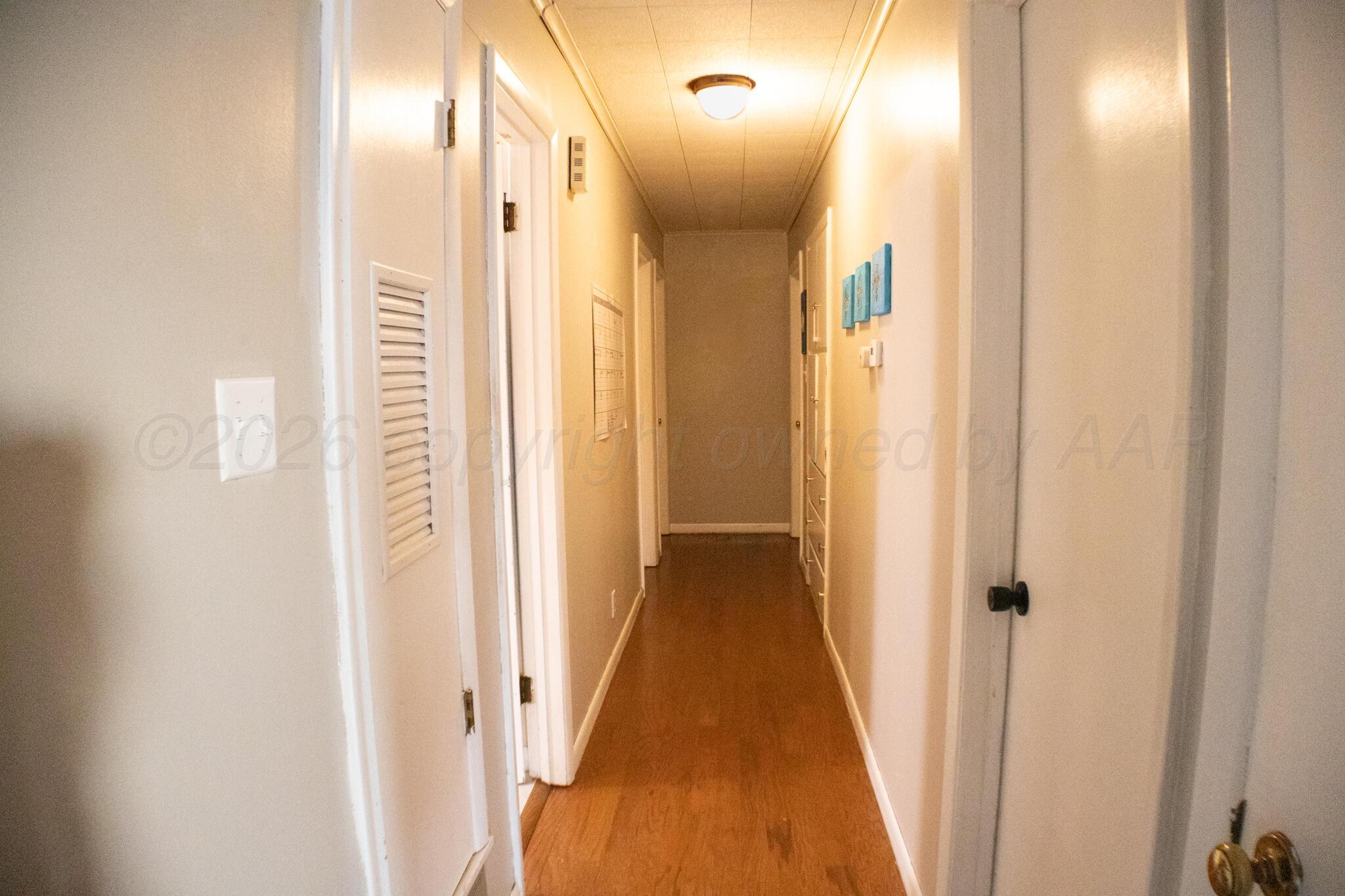 4711 South Rusk Street Amarillo, TX 79110 - Photo 12 of 24 a view of a hallway with a door and staircase