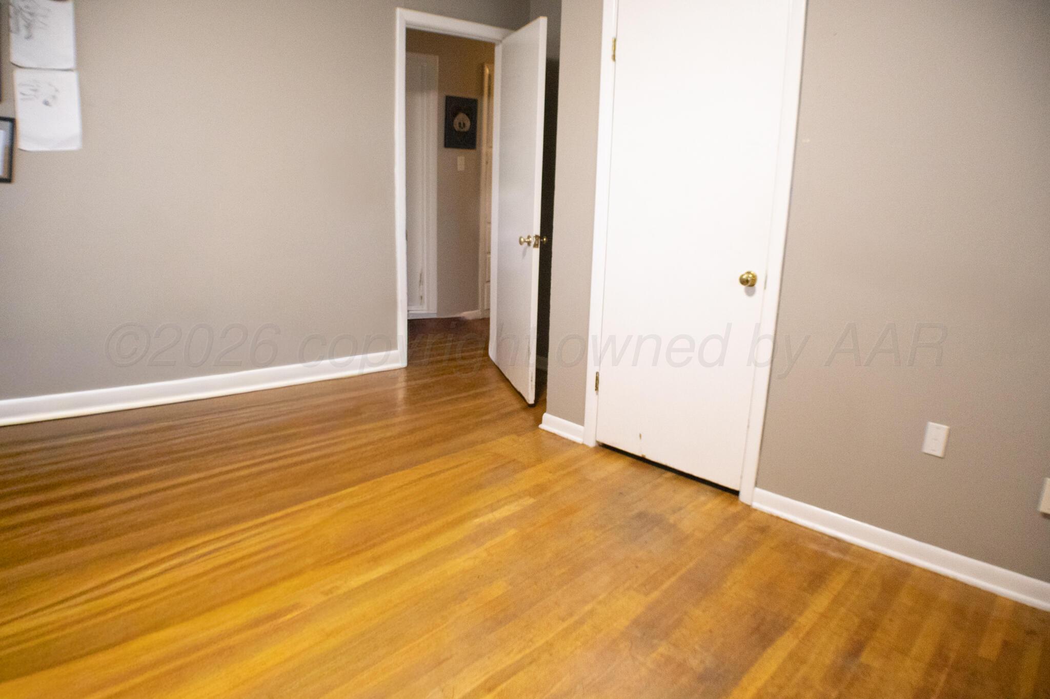 4711 South Rusk Street Amarillo, TX 79110 - Photo 20 of 24 a view of an empty room with wooden floor