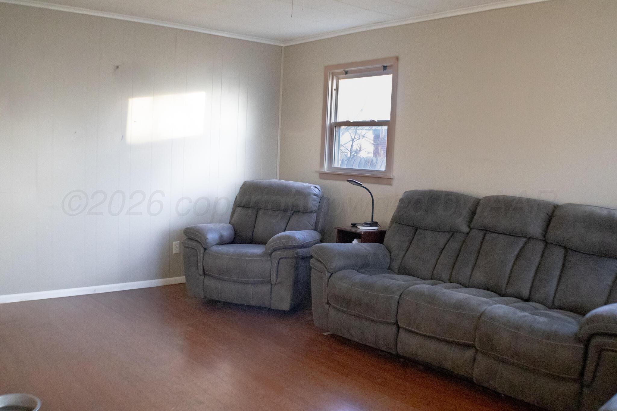 4711 South Rusk Street Amarillo, TX 79110 - Photo 3 of 24 a living room with furniture and a window