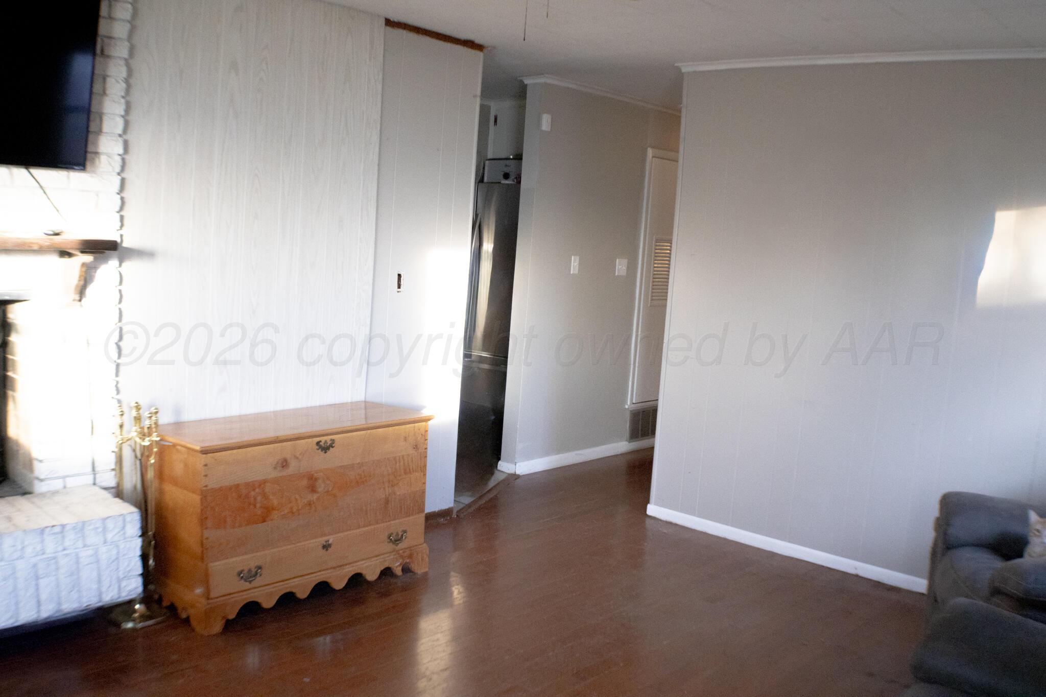 4711 South Rusk Street Amarillo, TX 79110 - Photo 4 of 24 an empty room with wooden floor windows and entrance