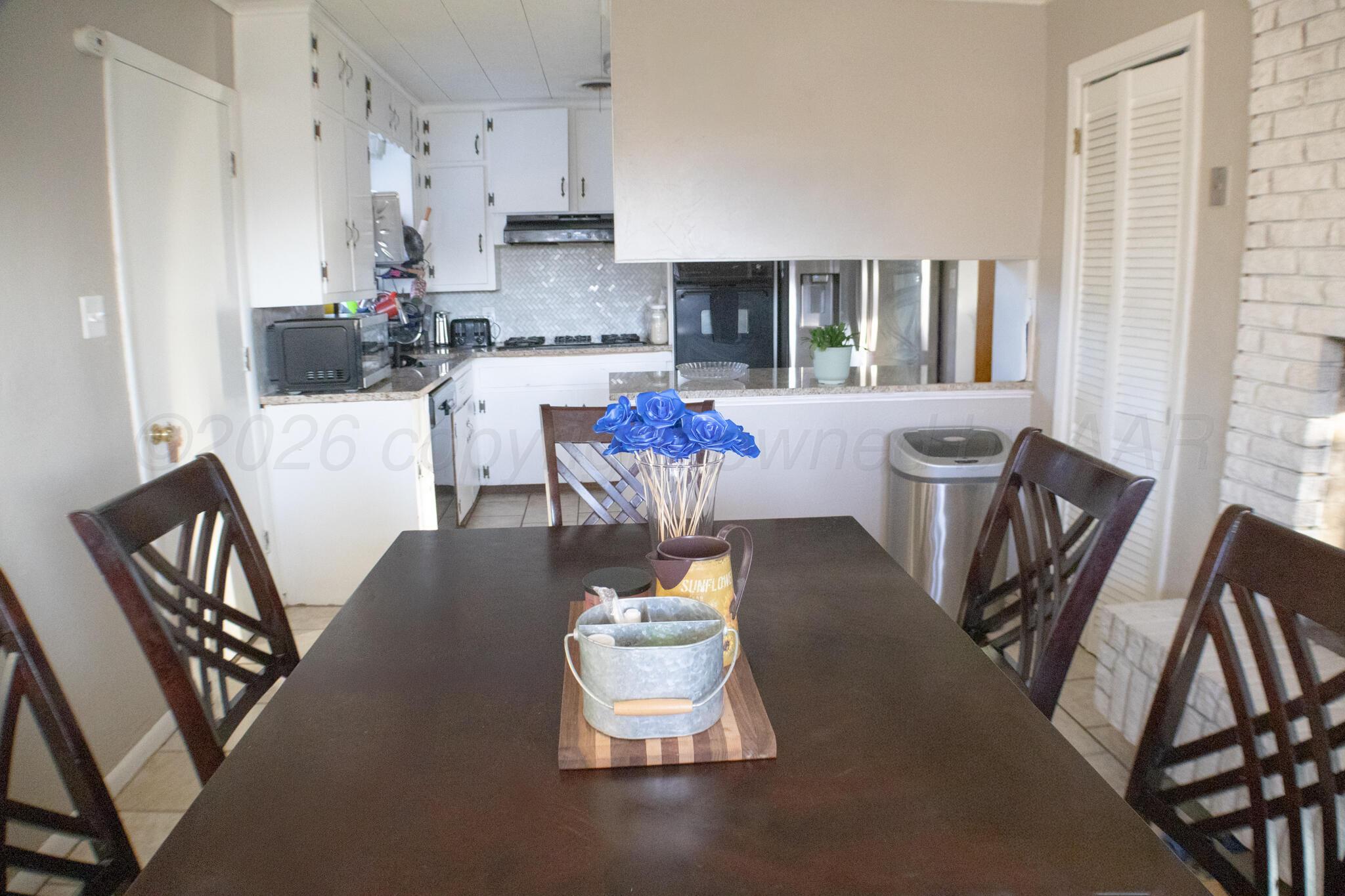 4711 South Rusk Street Amarillo, TX 79110 - Photo 9 of 24 a dining room with furniture and wooden floor