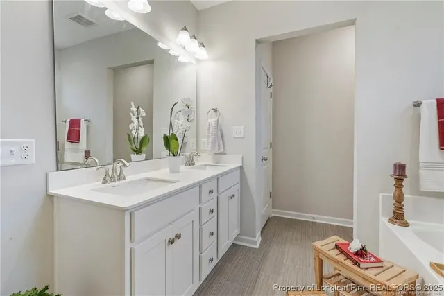 a bathroom with a double vanity sink and a mirror