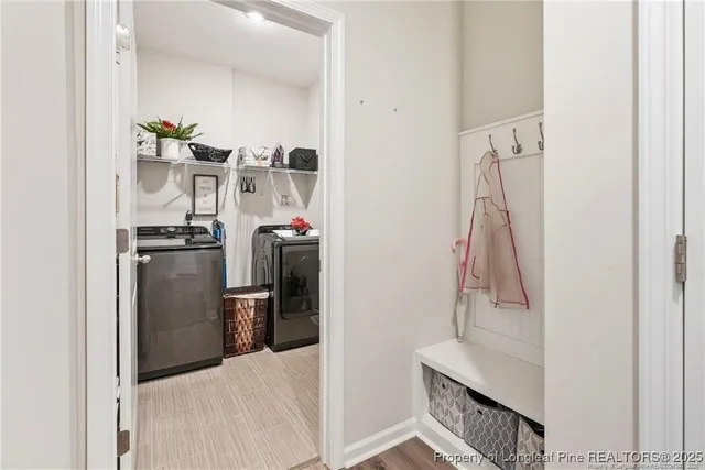 a room with white cabinets and stainless steel appliances