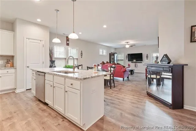 a kitchen with cabinets and chairs